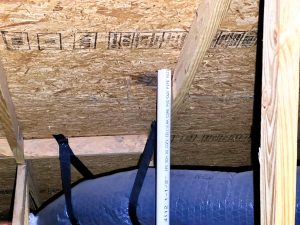 Visible-damaged-roof-decking-visible-in-the-attic-scaled